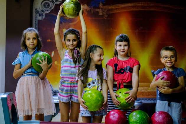 Kids holding bowling balls